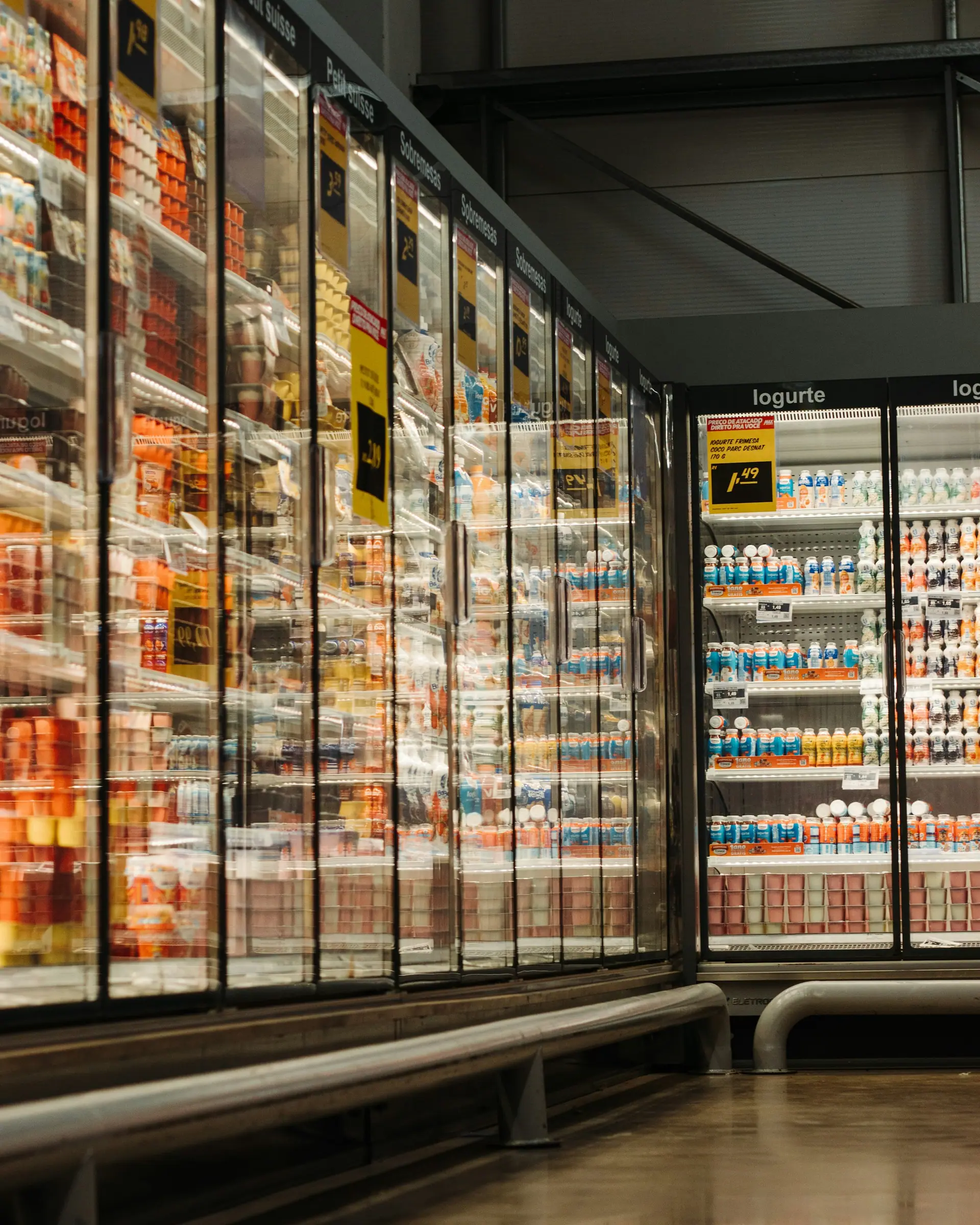 Refrigerated glass-door display cases in a supermarket aisle