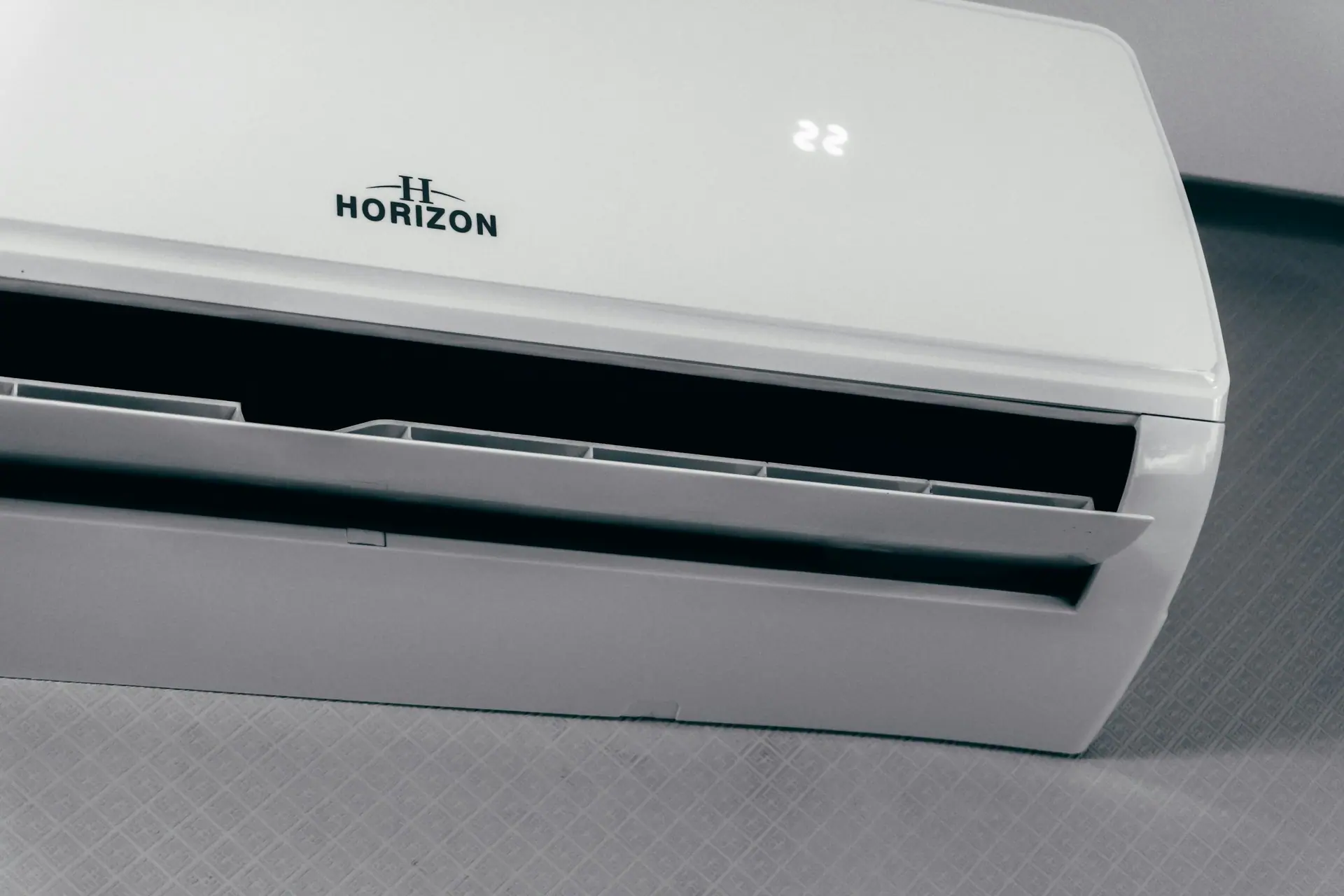 Indoor split air conditioner unit, its display reading 22 degrees